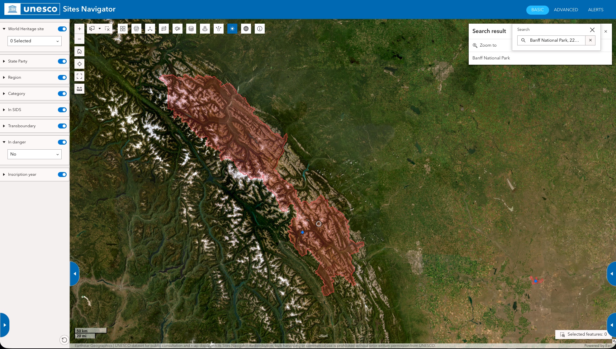 UNESCO Sites Navigator satellite view of Banff National Park, Canada, with the World Heritage site boundary outlined in red over mountain and forest terrain.