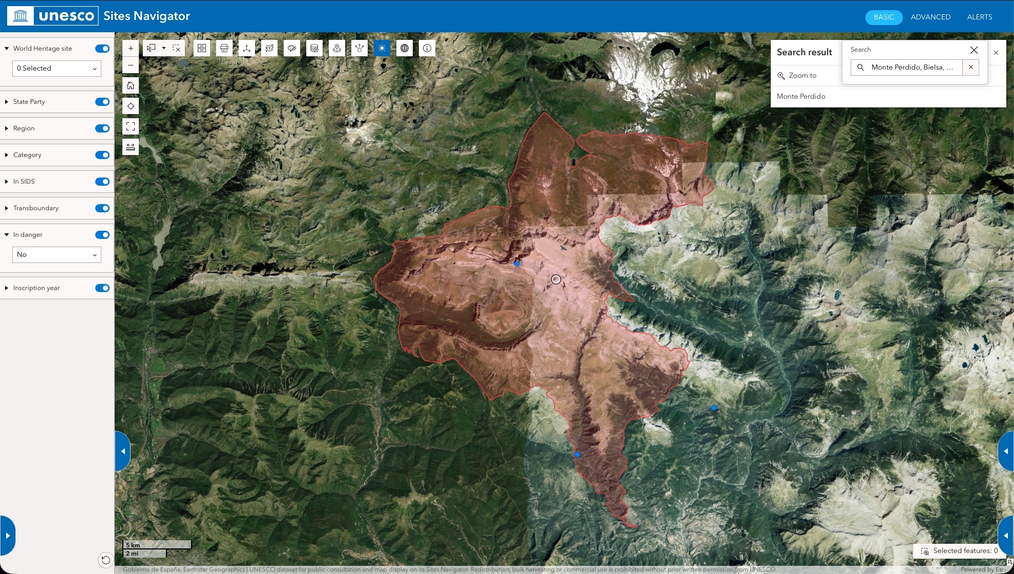 UNESCO Sites Navigator satellite view of Monte Perdido in the Pyrenees, with the World Heritage site boundary outlined in red over mountain terrain.