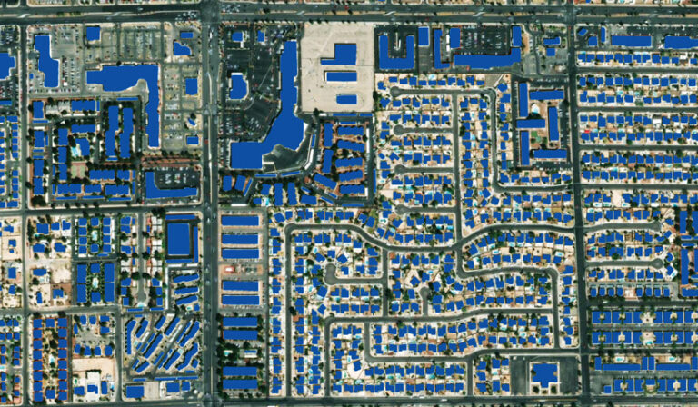 A top-down aerial view of a city grid, with all building footprints shown in solid blue.