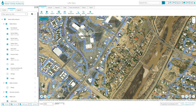 A screenshot of a GIS interface for the Albuquerque Bernalillo County Water Utility Authority. The main view shows an aerial map of a city with a blue water utility network overlay. A left panel lists map layers, including "Water Device," "Water Junction," and "Water Line."