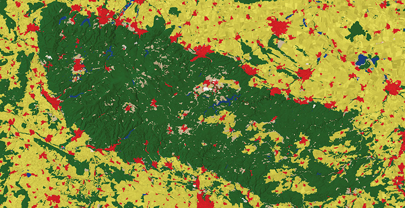 A color-coded land use map with a large dark green forested area, surrounded by yellow agricultural land.