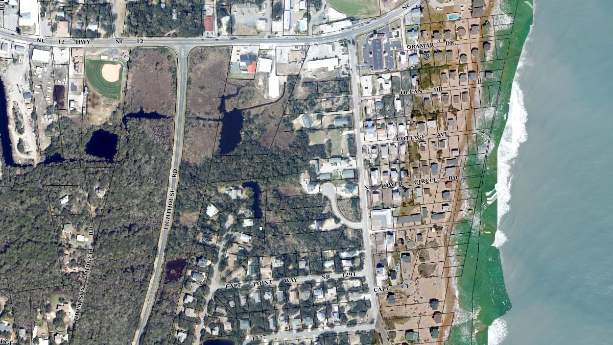 Aerial parcel map of Rodanthe, NC showing NC Highway 12 and residential lots on a narrow barrier island strip beside the ocean.