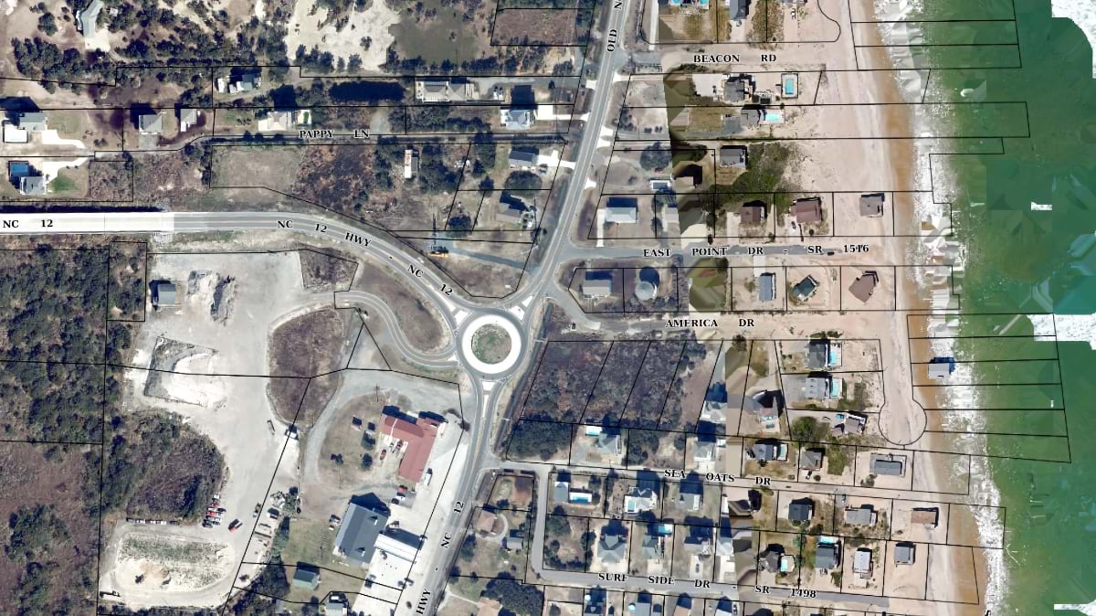Close aerial parcel view of Buxton's Tower Circle Road area showing vacant oceanfront lots where homes have been lost to erosion.