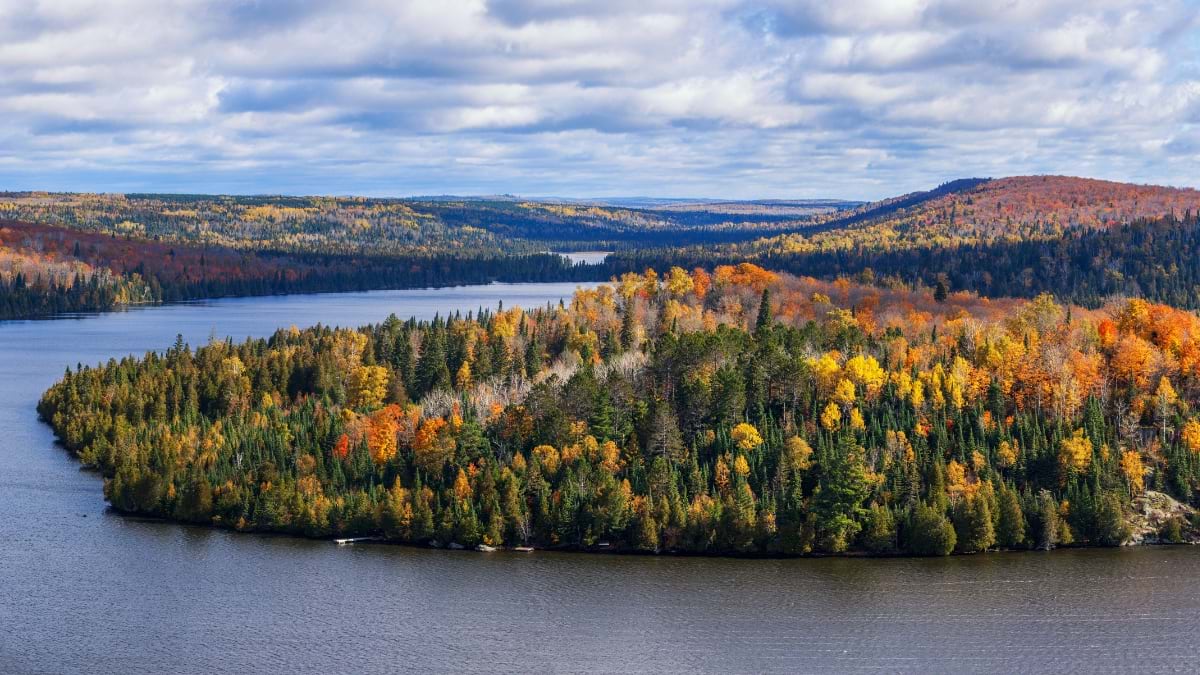 Aerial view of fall foliage surrounding a lake in Superior National Forest, Minnesota.