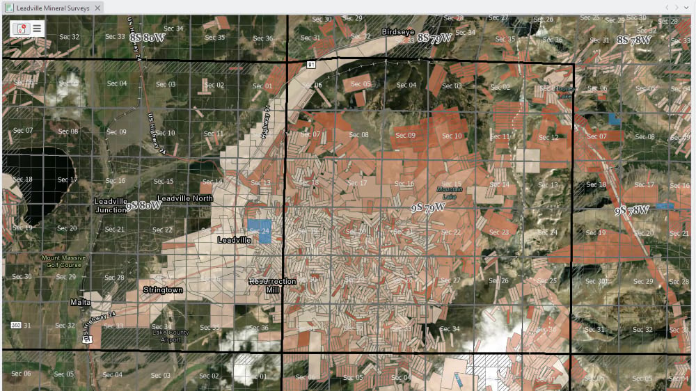 Aerial imagery of Leadville, Colorado overlaid with orange-toned mineral survey polygons showing hundreds of historic mining claims against the PLSS grid.