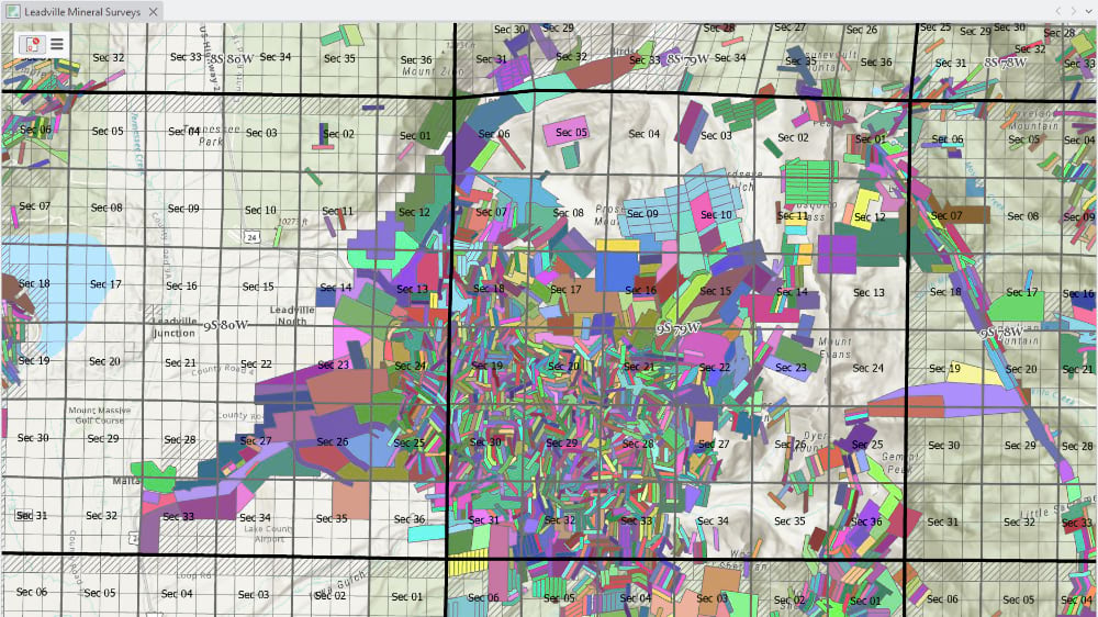 Multicolor mineral survey polygons over a topo basemap of Leadville, Colorado, each color representing a distinct historic mining claim.