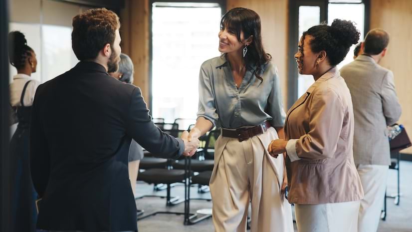 A group of professional people shaking hands at an event