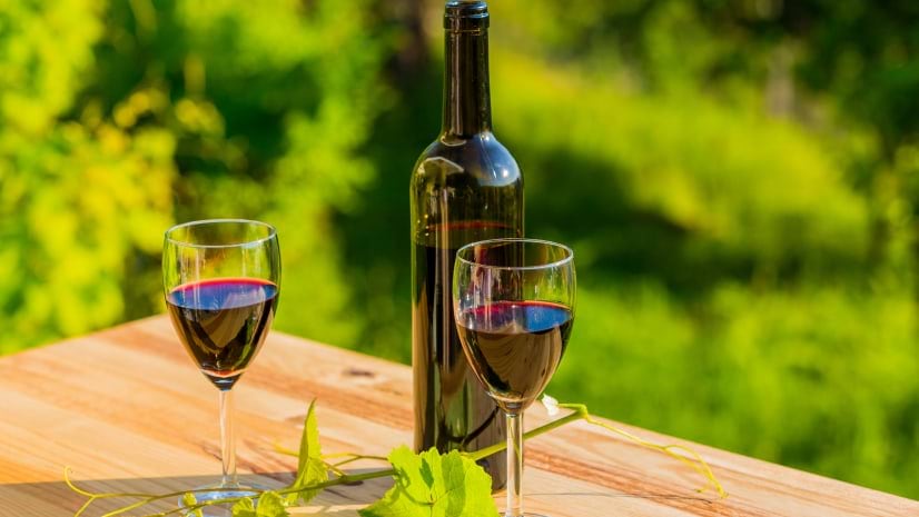 A bottle and two glasses of wine illustrate a story about Silver Oak Cellars