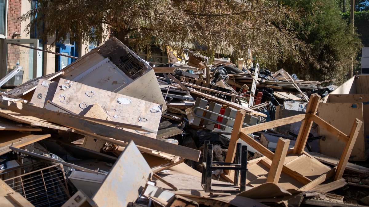 Damaged furniture and appliances piled outside a building after flooding from Hurricane Helene.
