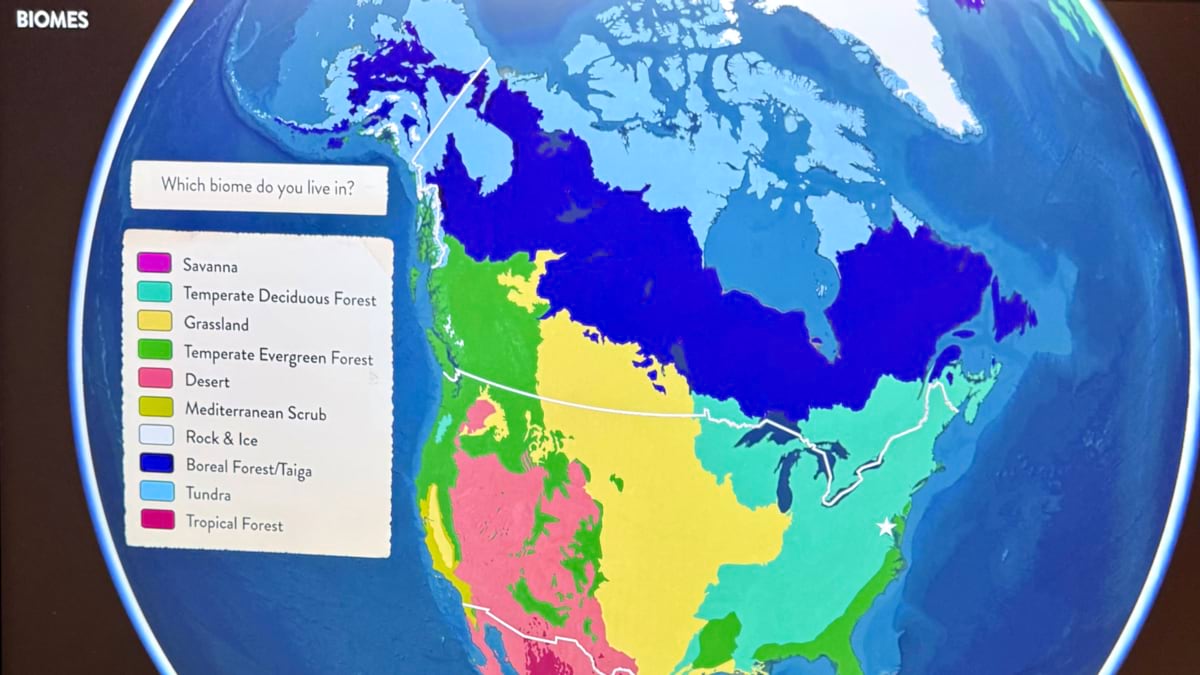 Globe view of North America color-coded by biome — savanna, temperate deciduous forest, grassland, temperate evergreen forest, desert, Mediterranean scrub, rock and ice, boreal forest/taiga, tundra, and tropical forest — with a prompt asking visitors which biome they live in.