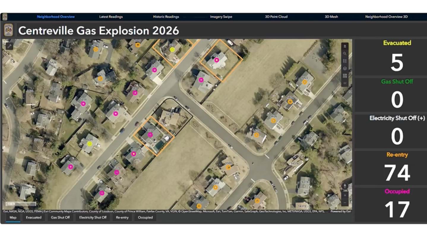 Aerial GIS dashboard view of a neighborhood with color-coded status markers on dozens of homes.