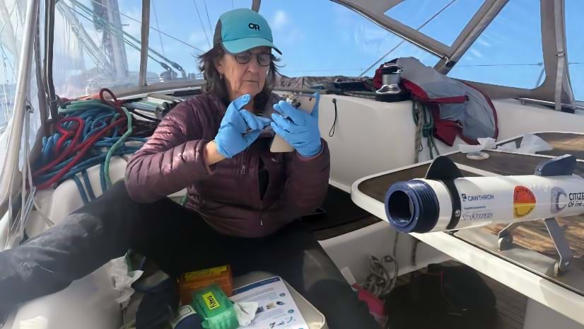 A woman conducting research on a boat