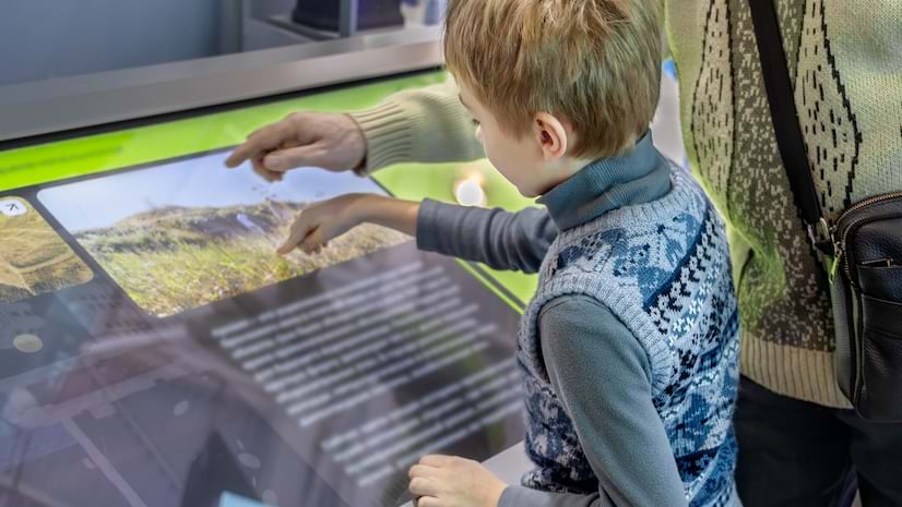 A child interacting with a museum display