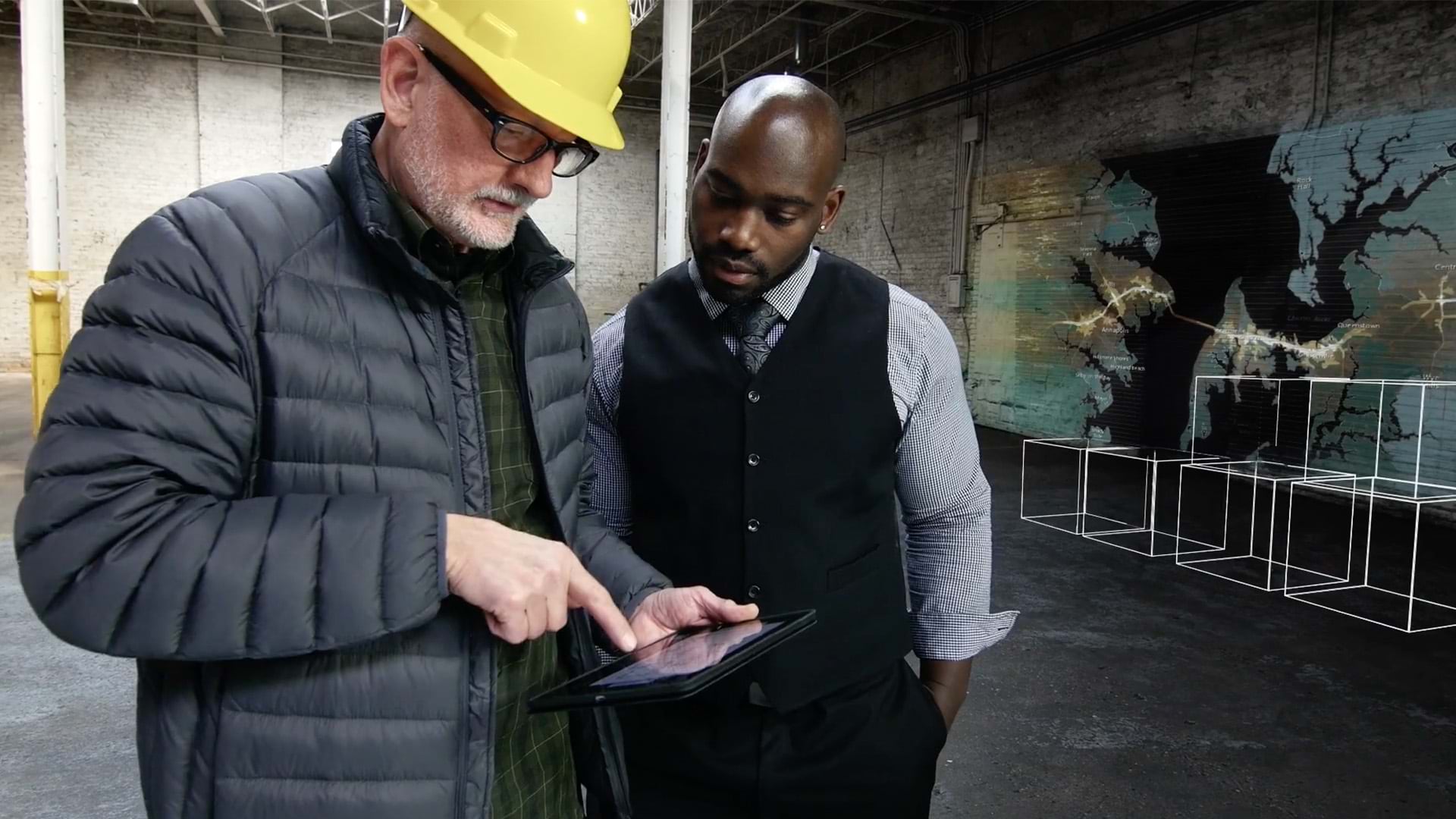 Two people looking at a tablet together in a warehouse
