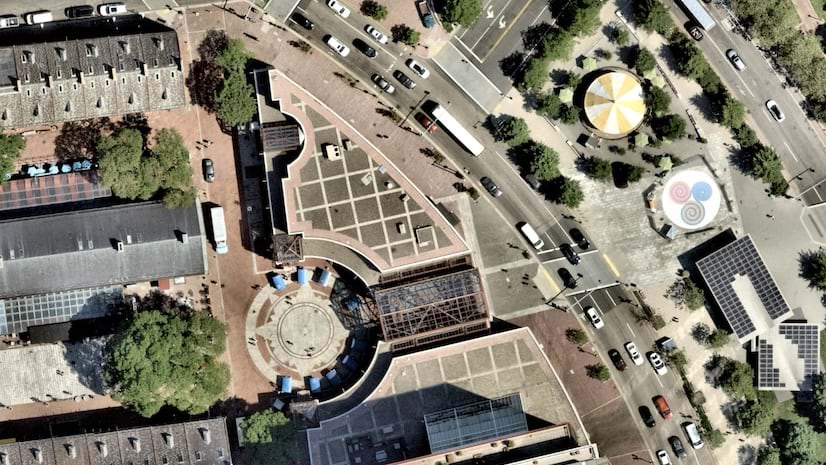 The World Imagery basemap in ArcGIS Living Atlas of the World showing an aerial view of road, cars, and buildings