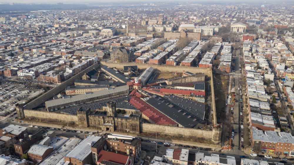 Aerial view of Eastern State Penitentiary's radial cell blocks and surrounding Philadelphia rowhomes.