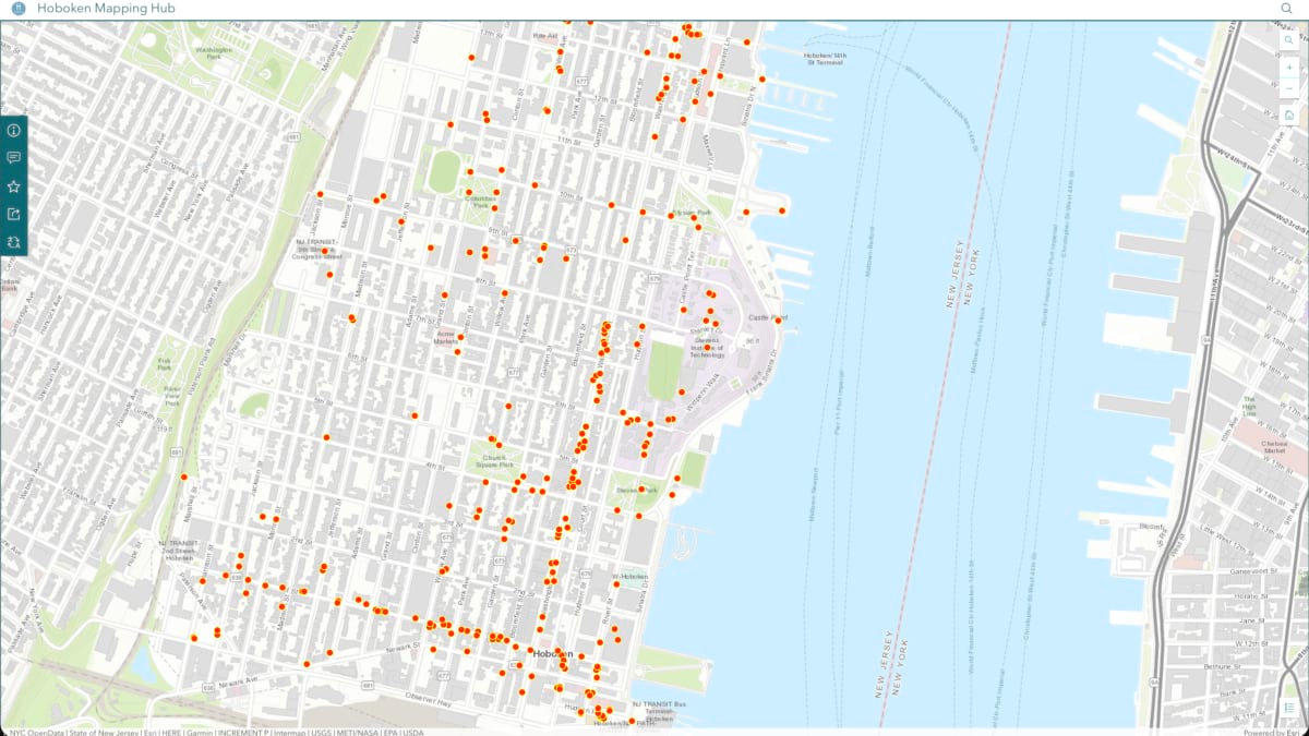 Orange dot markers across Hoboken's street grid showing bike rack locations, with the Hudson River and Manhattan visible to the right.