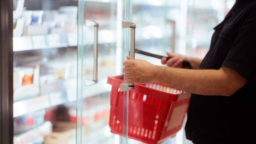 A shopper with a grocery basket represents the practice of retail site selection