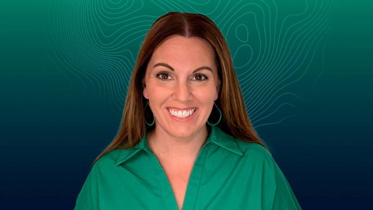 Smiling woman with long brown hair, wearing a green collared shirt and matching earrings, in front of a teal background with light green topographic lines.