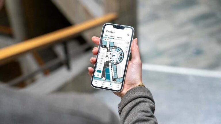 A person holding a smartphone that shows a detailed map