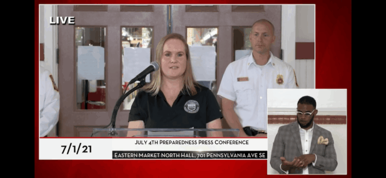 A screenshot of a live press conference and woman speaking at a podium
