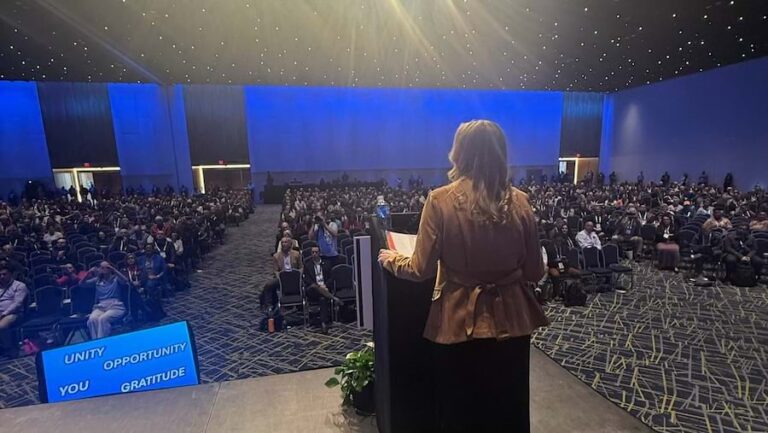 A person stage at a podium in front of an audience