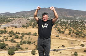Daniel Munoz lets his community mapping T-shirt shine atop the Pyramid of the Sun in the ancient Mesoamerican city of Teotihuacan, Mexico