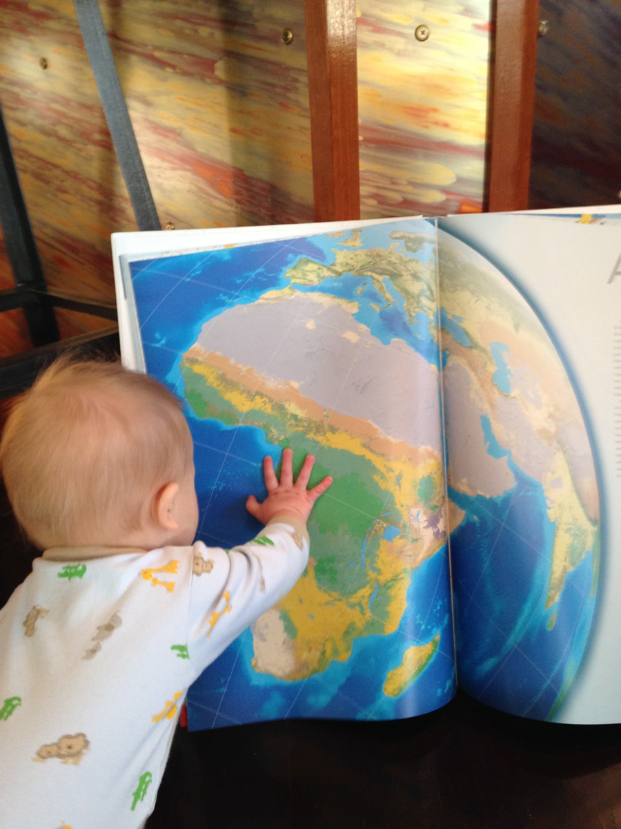 Miller familiarizes himself with the National Geographic World Atlas.