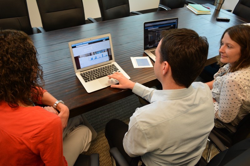 Courtney Bernardi (left) and Bethany Lavigno-Hountz, of Johns Creek Advantage, consult with Nick O'Day, Johns Creek senior GIS manager, about how to use open data for economic development.