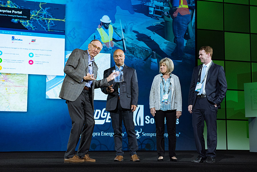 Representatives from SoCalGas and San Diego Gas & Electric accept their award from Dangermond.