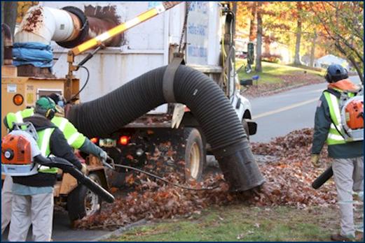 Public Works Department employees collect leaves in a South Windsor residential neighborhood.