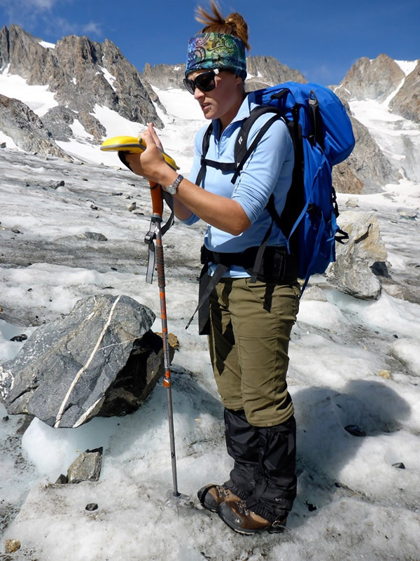 GIST student Chelsea Cheney collects elevation data for use by the University of North Dakota for some of the university's research into glacial recession.