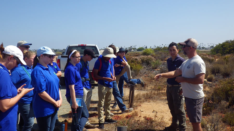 Kurt Roblek (far right) and Pek Pum from the US Fish and Wildlife Service introduce the 4-H team to Limonium sinuatum, also known as sea lavender or statice.