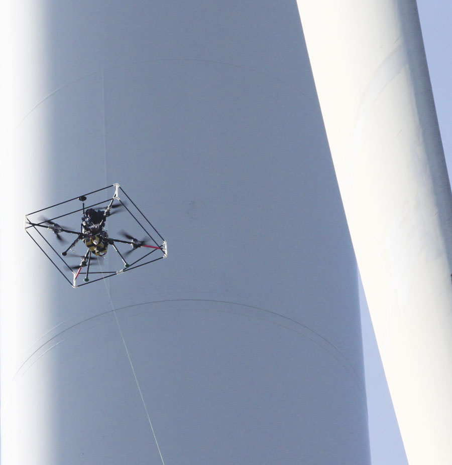 A quadcopter captures images of a wind turbine blade that are then added to an asset management map.