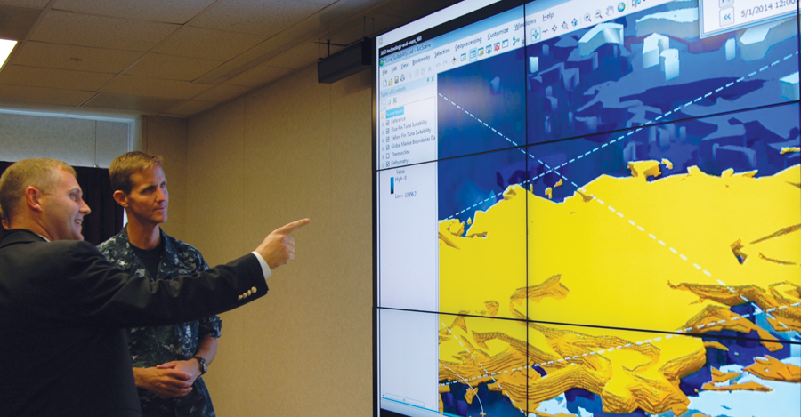 Rear Admiral Timothy C. Gallaudet, commander of the Naval Meteorology and Oceanography Command, with Brian Lehman of the Esri Defense team, discussing the marriage of ocean science and GIS.