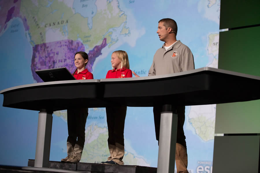 Fourth graders Rikki Vaughn (left) and Kylie Miller, with their teacher Josh Worthy, spoke at the Esri User Conference about how they used ArcGIS Online for class projects. The students attend Sonora Elementary School in Springdale, Arkansas.