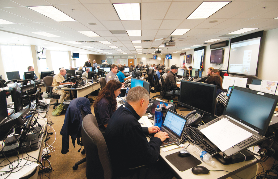 Geospatial analyst Tabatha Waldron used an ArcGIS Online Group to share information with the public, decision makers, and other SEOC staff. Photograph courtesy of Micki Trost, Colorado DHSEM PIO Geospatial analyst Tabatha Waldron used an ArcGIS Online Group to share information with the public, decision makers, and other SEOC staff. Photograph courtesy of Micki Trost, Colorado DHSEM PIO