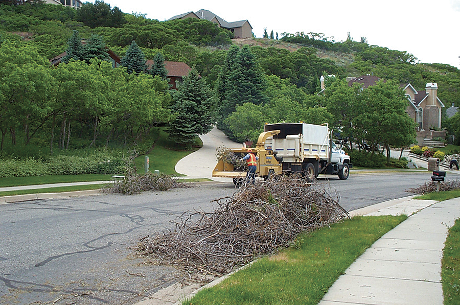 Tree branches being chipped for mulch during Sandy City's spring bulk waste cleanup.