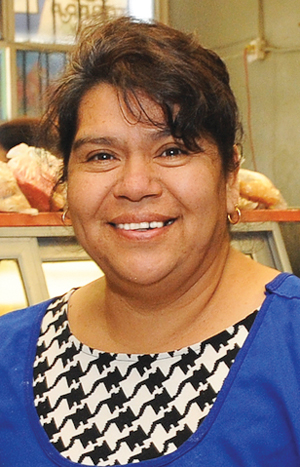 Bertha, Grameen America member, used her microloan to purchase ingredients in bulk, increasing production in her bakery. Bertha, Grameen America member, used her microloan to purchase ingredients in bulk, increasing production in her bakery.