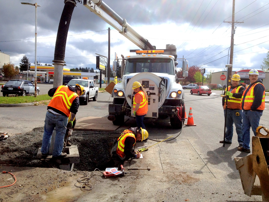 A Pierce County Public Works Road Operations crew multitasks as they perform a targeted annual storm drainage structure cleaning alongside a maintenance crew performing a needed repair to the storm water conveyance system found during annual inspections. A work order was immediately generated when the inspection data was checked back into the file geodatabase because the value entered into the custom ArcGIS form triggered the activity.
