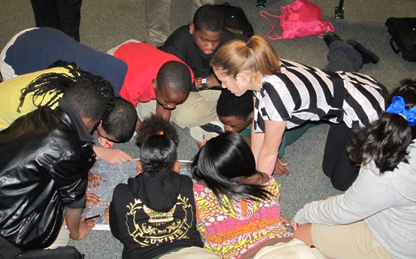 Molly Richardson ( right), an intern at the US Army Corps of Engineers Huntsville Center, helps sixth graders at Ed White Middle School in Huntsville, Alabama, with a GIS activity. The school was among six schools in Alabama that observed GIS Day. (Photo by Jo Anita Miley)