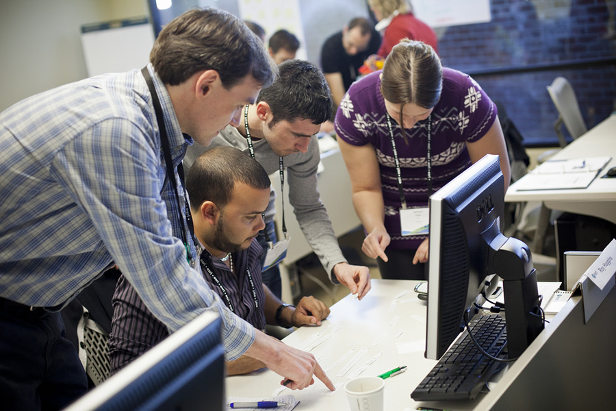 A small group cooperates during hands-on training.