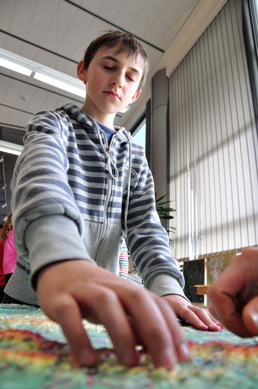 A student from the J. A. Komenského Christian Elementary School in Liberec reads a relief map just by touching it. A student from the J. A. Komenského Christian Elementary School in Liberec reads a relief map just by touching it.