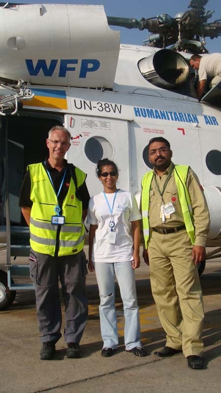 Nadika Senadheera stands with her colleagues in front of a Humanitarian Air helicopter that dropped food to the Pakistanis during the 2010 floods.