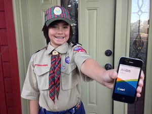 Cub Scout Joshua Perry prepares to collect sales information using Collector for ArcGIS.