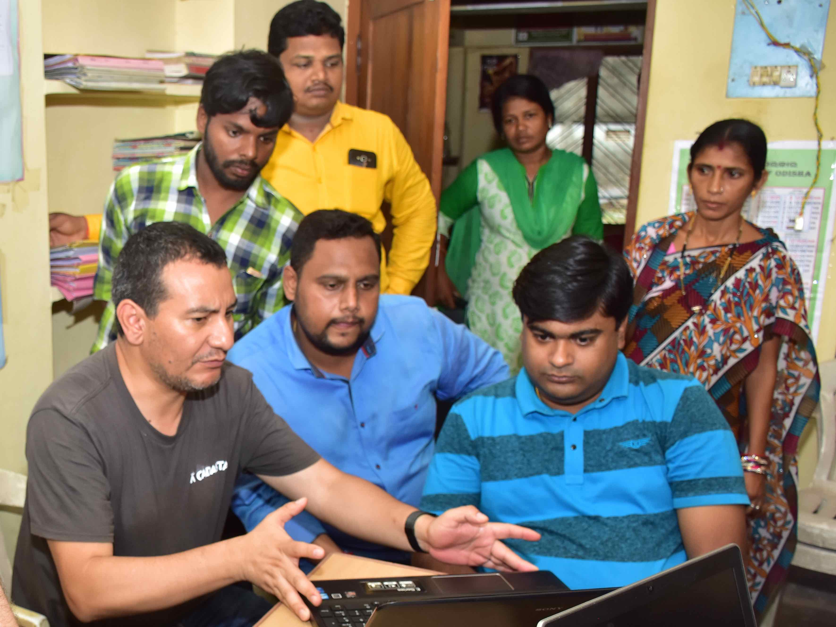 community gathered around a computer
