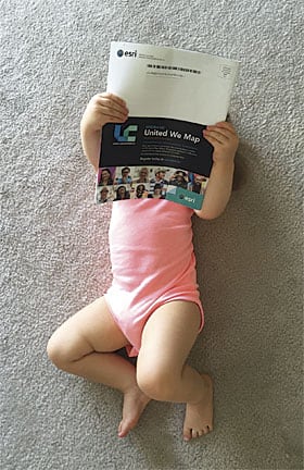 Annabelle Henderson kicks back to read the latest issue of ArcUser at the family's home in Miami