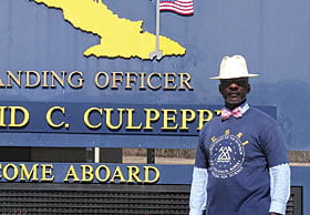 Dr. Lemuel Patterson, a STEM education instructional systems specialist poses at the welcome sign to Guantanamo Bay