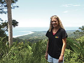 Amy Work shows off her Esri T-shirt above the tombolo in Costa Rica