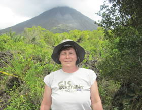 Peggy Staske, an engineering information technician posed in her Esri T-shirt at the Arenal Volcano in La Fortuna